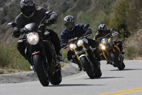 A tight group of riders leaning through a corner together