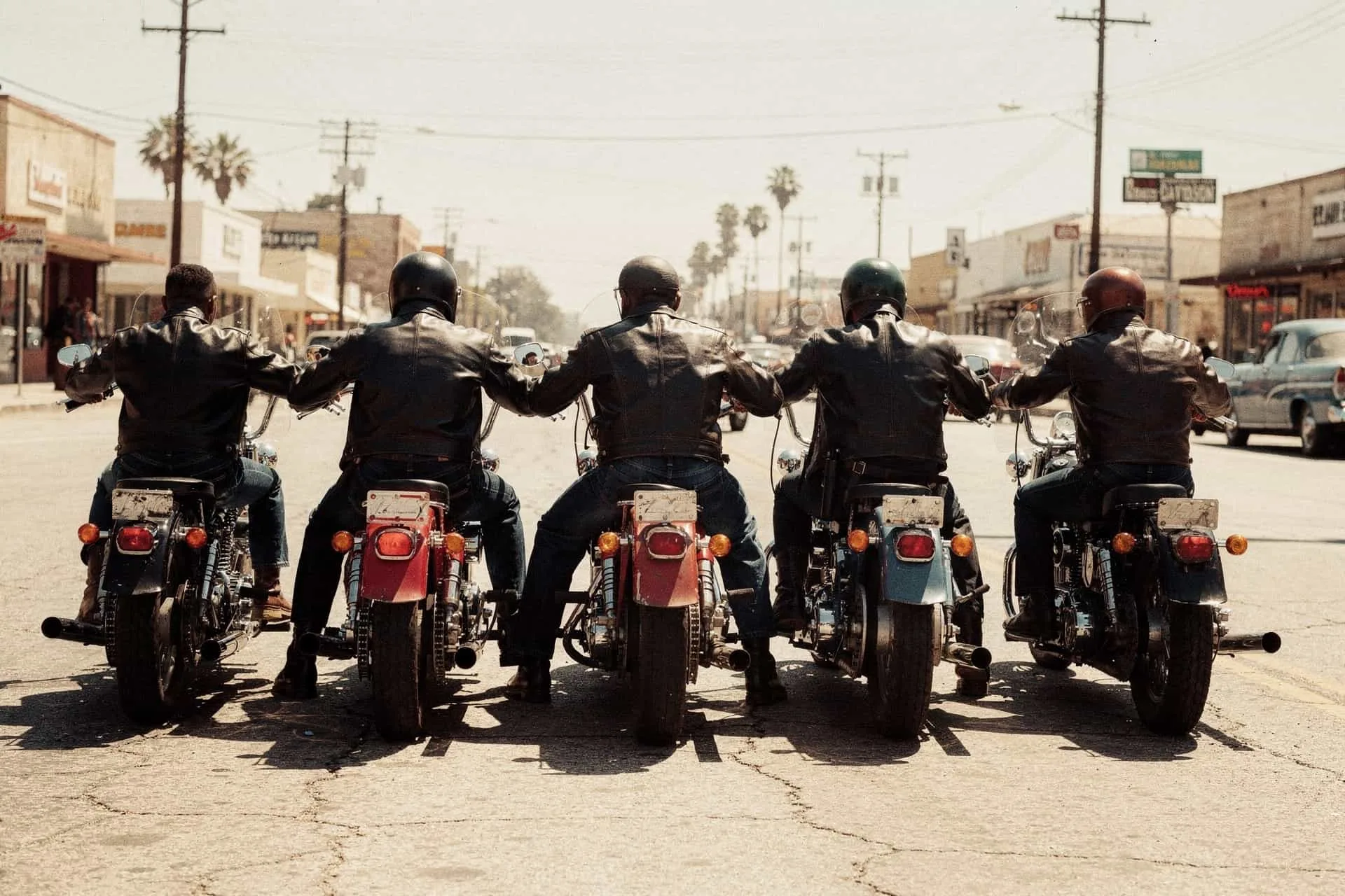 A row of riders parked together on an open street